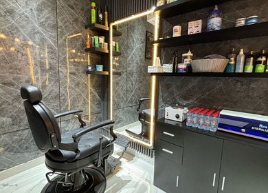 Stylish interior of YAZ Barbershop - Al Kasir in Abu Dhabi, AE featuring leather chair and grooming products.