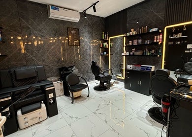 Luxurious interior of YAZ Barbershop - Al Kasir in Abu Dhabi, AE with sleek chairs and modern decor.