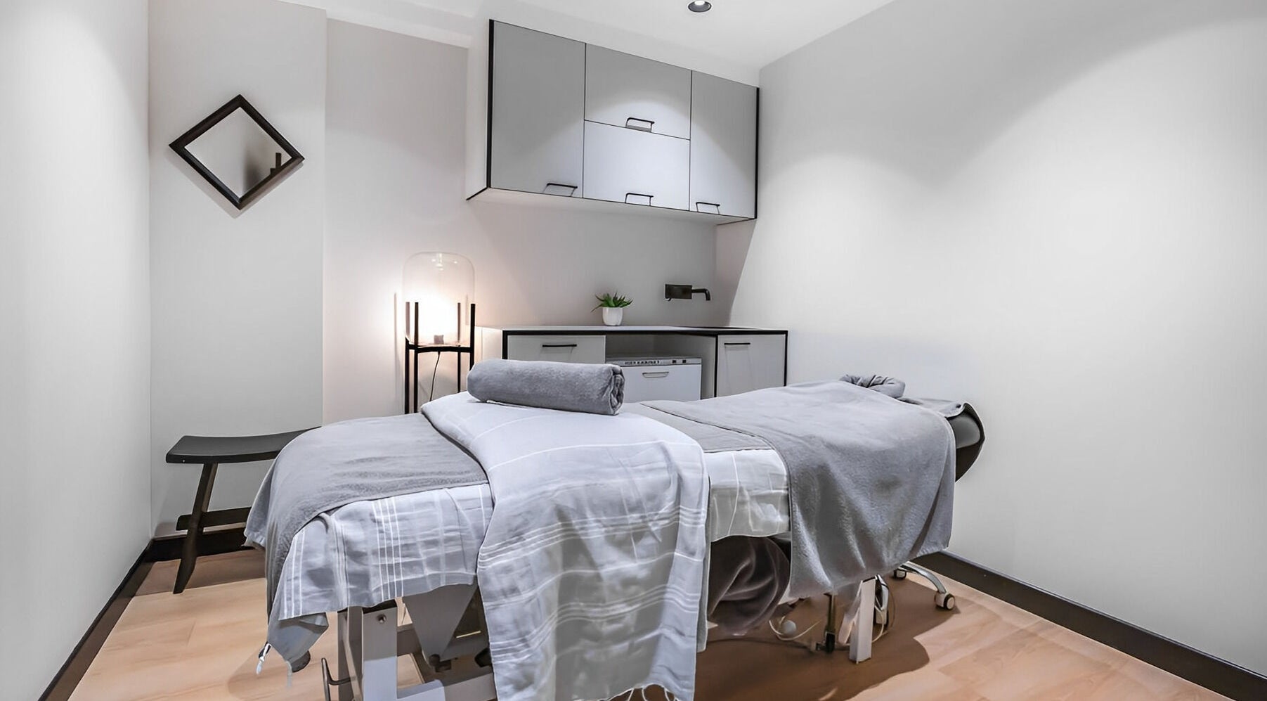 Calm treatment room at Skintopia - Old Bank Arcade, Wellington, NZ, featuring a massage table and soft lighting.