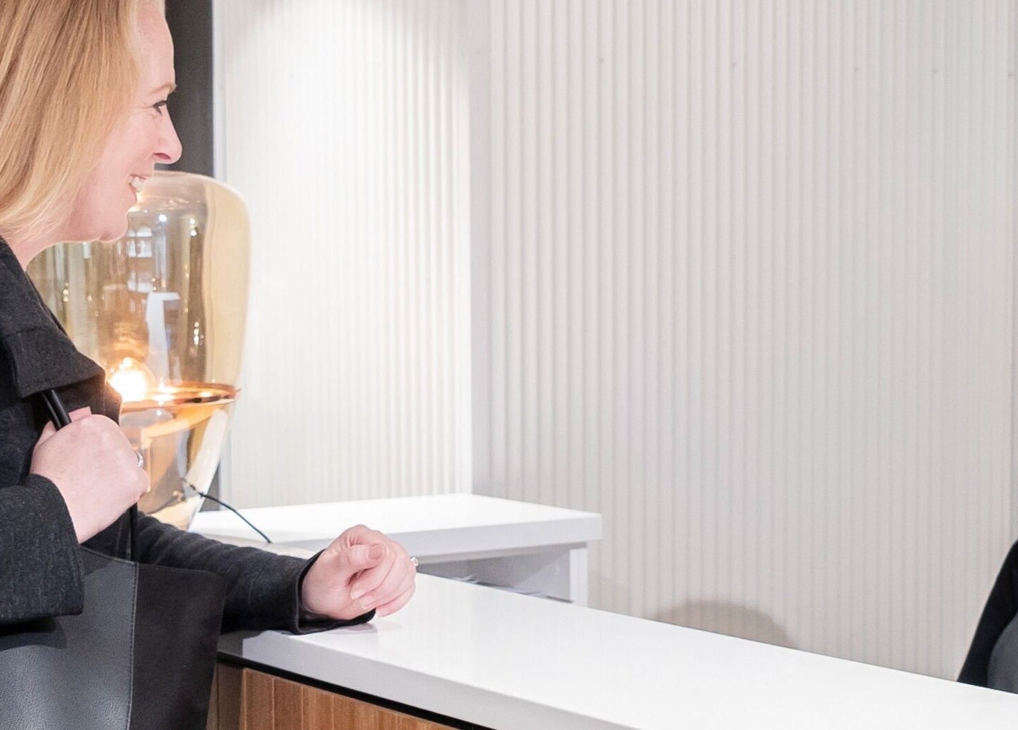 Guest is warmly greeted at Skintopia - Old Bank Arcade, Wellington, Wellington, NZ reception desk.