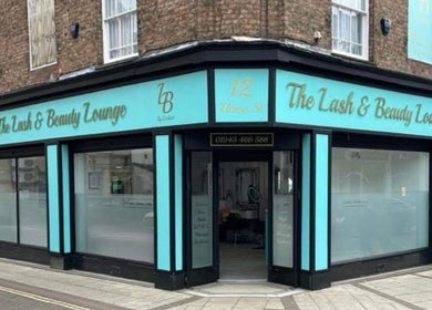 Front view of The Lash & Beauty Lounge by Carlene, Wisbech, England, GB with elegant blue storefront.