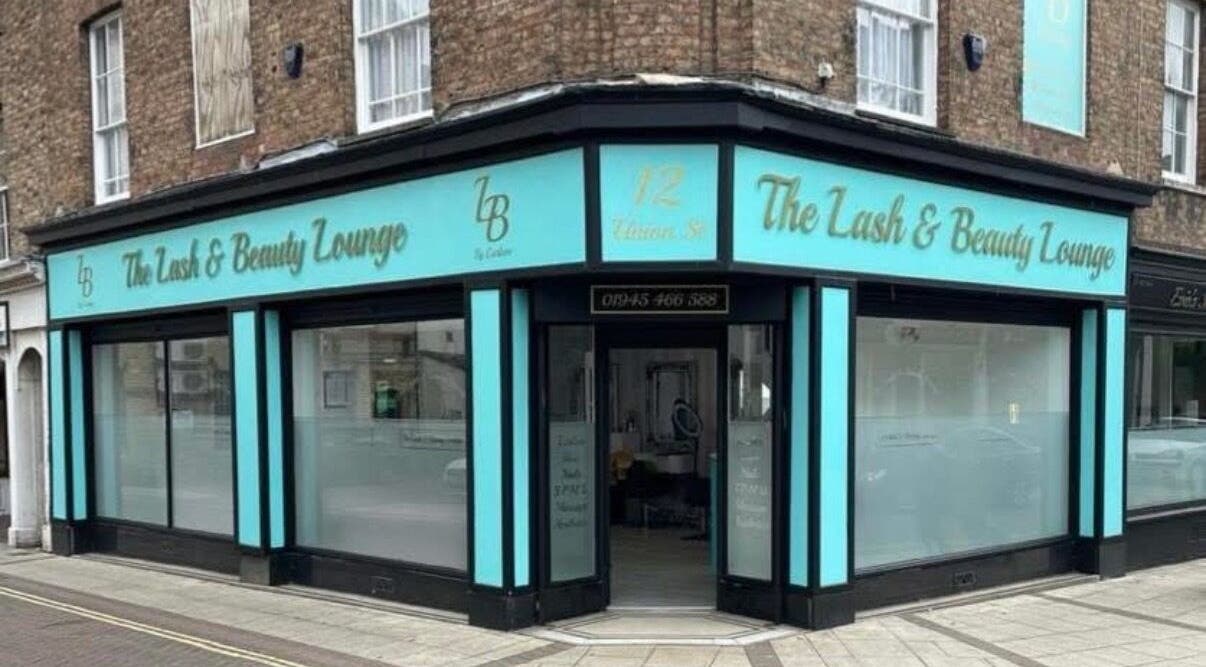 Front view of The Lash & Beauty Lounge by Carlene, Wisbech, England, GB with elegant blue storefront.