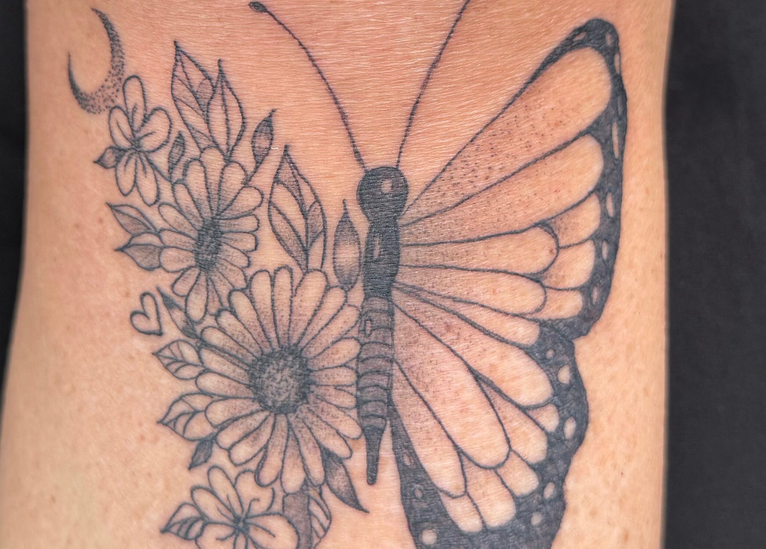 Detailed butterfly tattoo with flowers at The Lash & Beauty Lounge by Carlene, Wisbech, England, GB.