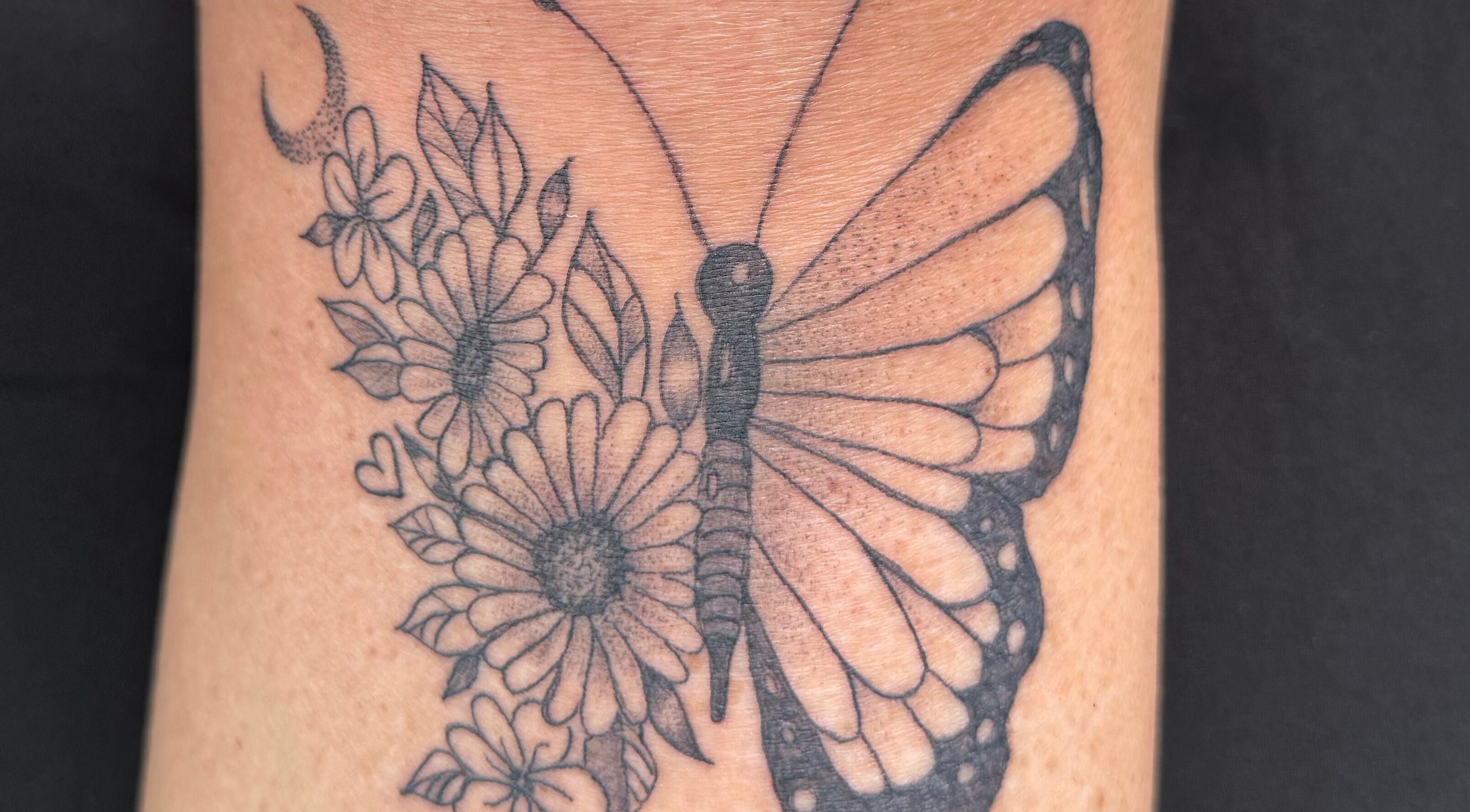 Detailed butterfly tattoo with flowers at The Lash & Beauty Lounge by Carlene, Wisbech, England, GB.