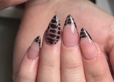 Leopard print nail design at Thebeautyroom, Bulkington, England, GB. Trendy stiletto manicure in stylish black.