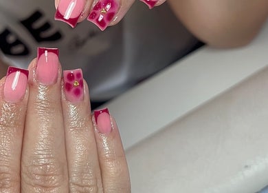 Stylish floral and glossy pink nails at Thebeautyroom, Bulkington, England, GB.
