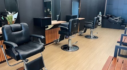 Chic interior of ReCalvo Barbershop in Shah Alam, Selangor, MY with stylish chairs and mirrors.