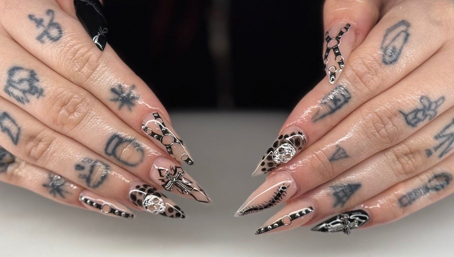 Stylish nail art at Ambers Beauty Room in Grimethorpe, England, GB, featuring intricate black and nude designs.