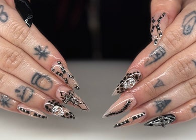 Stylish nail art at Ambers Beauty Room in Grimethorpe, England, GB, featuring intricate black and nude designs.