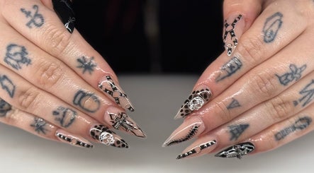 Stylish nail art at Ambers Beauty Room in Grimethorpe, England, GB, featuring intricate black and nude designs.
