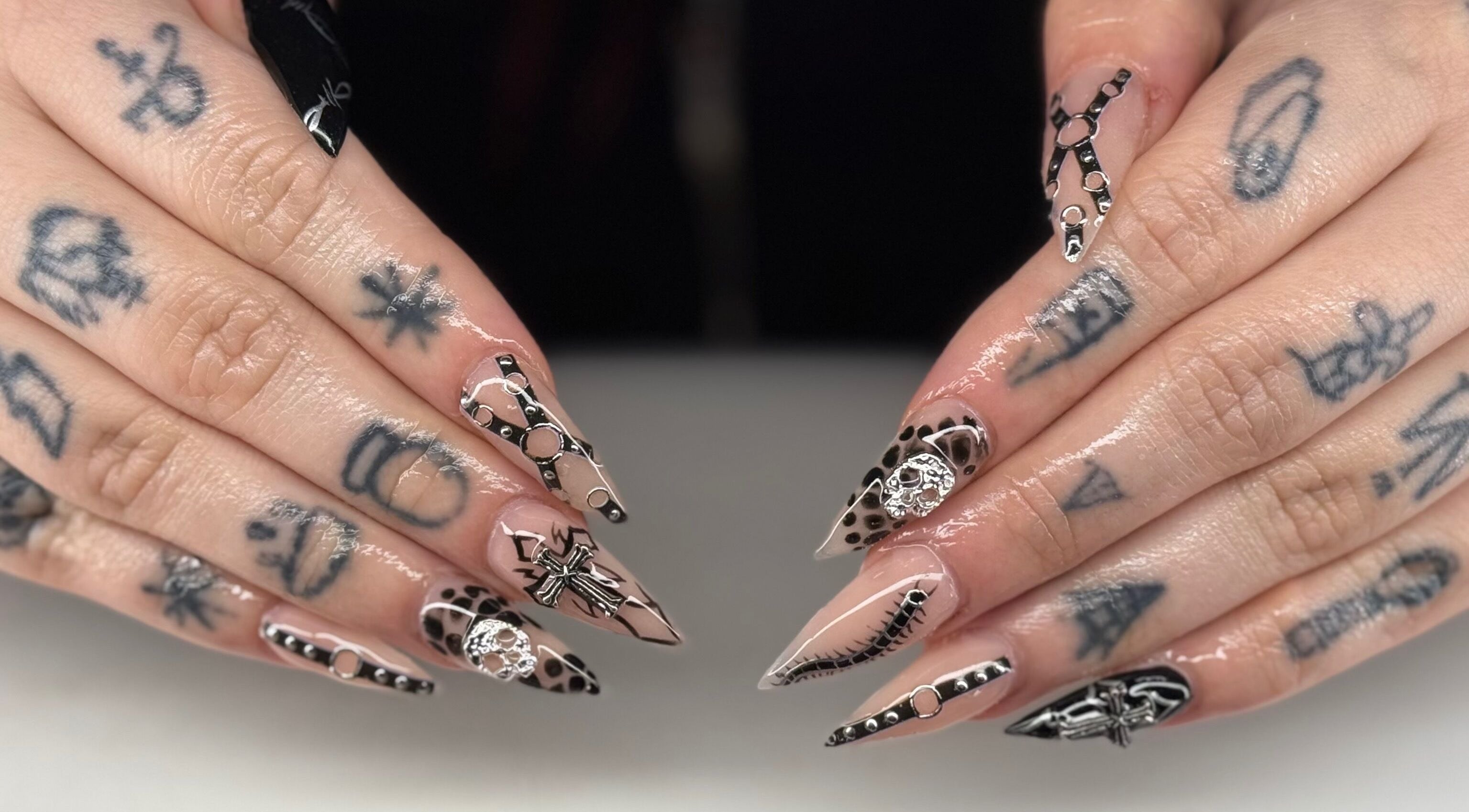 Stylish nail art at Ambers Beauty Room in Grimethorpe, England, GB, featuring intricate black and nude designs.