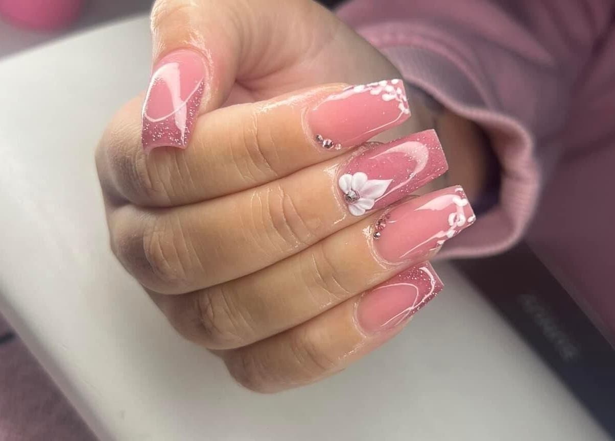 Elegant floral nail art at Ambers Beauty Room, Grimethorpe, England, GB showcasing intricate pink and white designs.