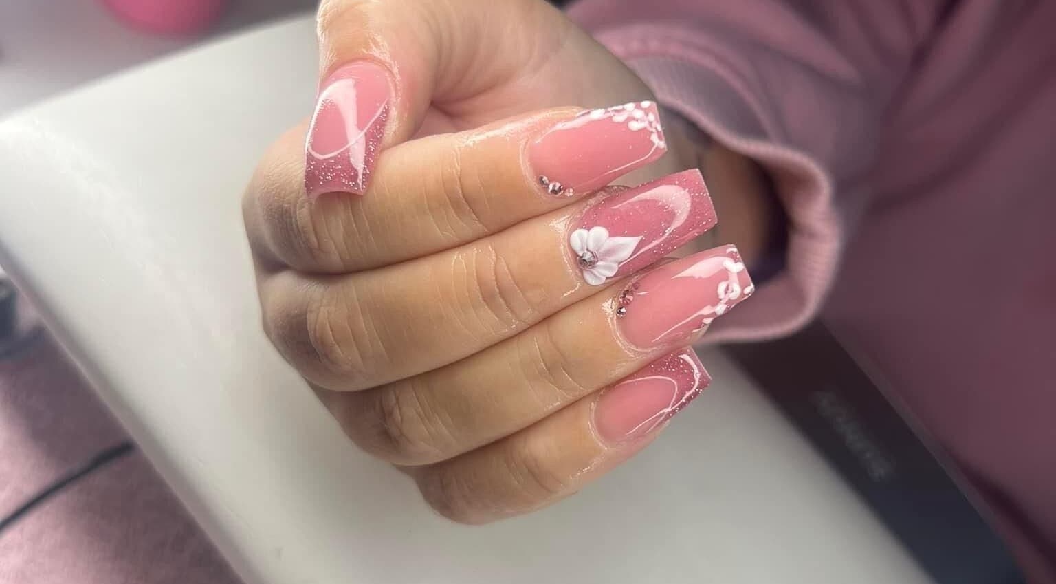 Elegant floral nail art at Ambers Beauty Room, Grimethorpe, England, GB showcasing intricate pink and white designs.