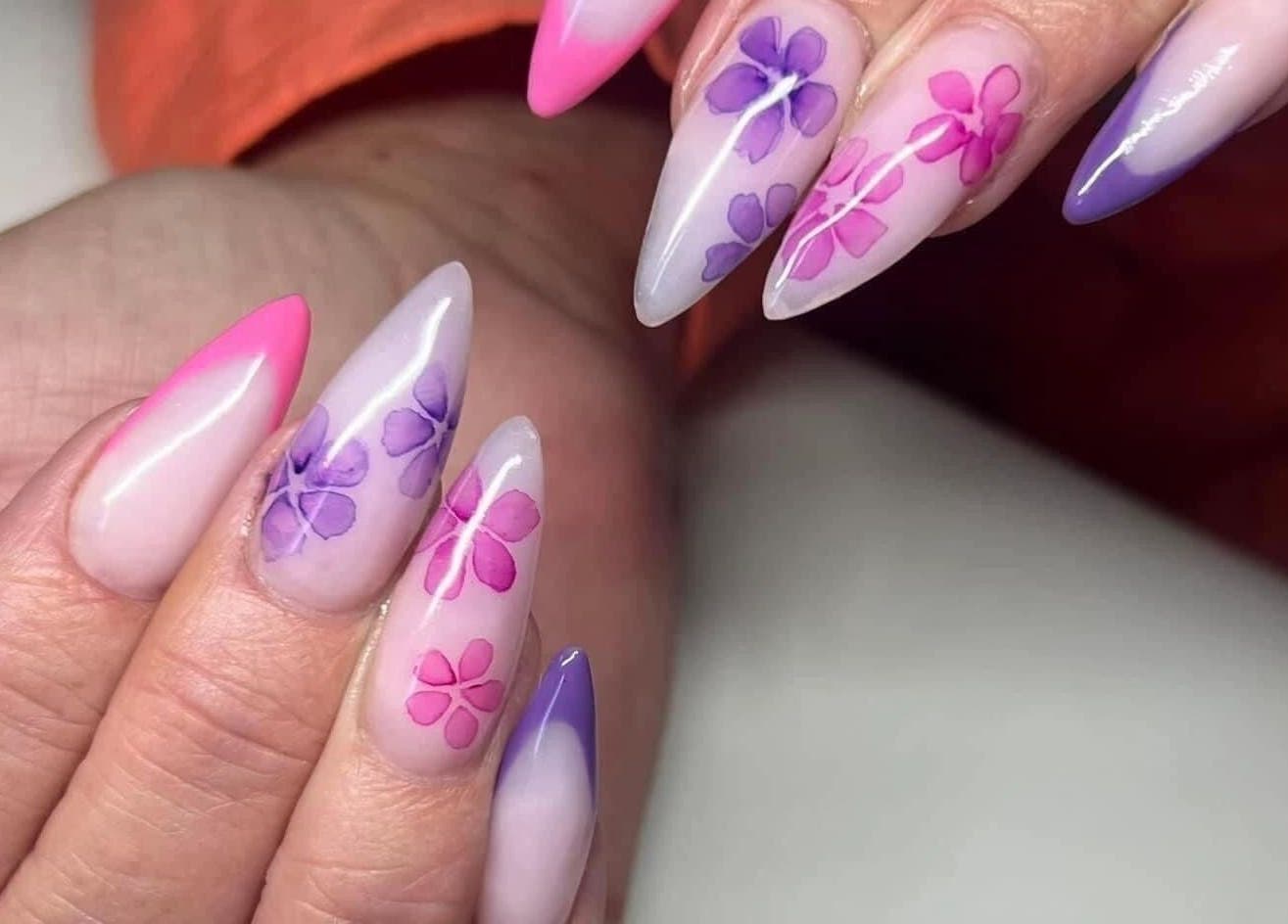 Floral nail art at Ambers Beauty Room, Grimethorpe, England, GB. Stunning pink and purple designs.