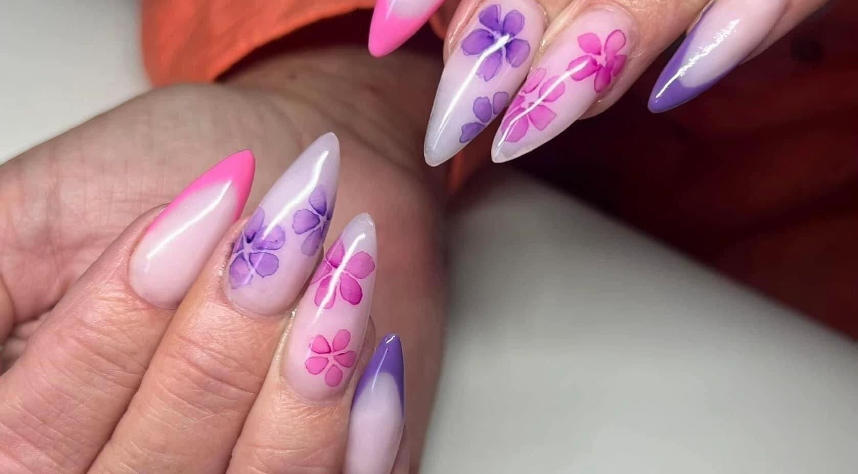 Floral nail art at Ambers Beauty Room, Grimethorpe, England, GB. Stunning pink and purple designs.