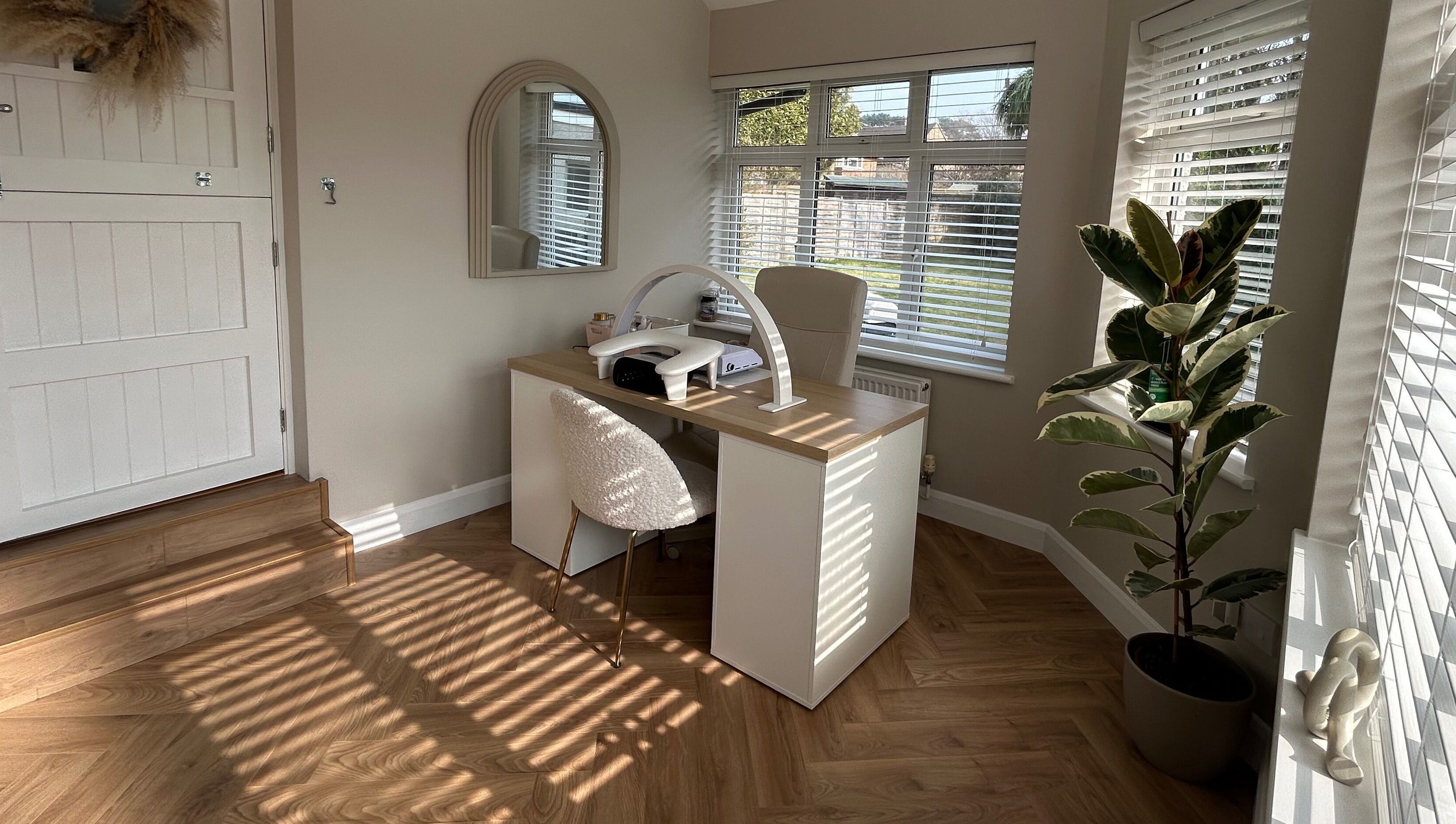 The Nail Room at Epsom Downs in Epsom, England, GB features a chic workspace with modern decor and natural light.