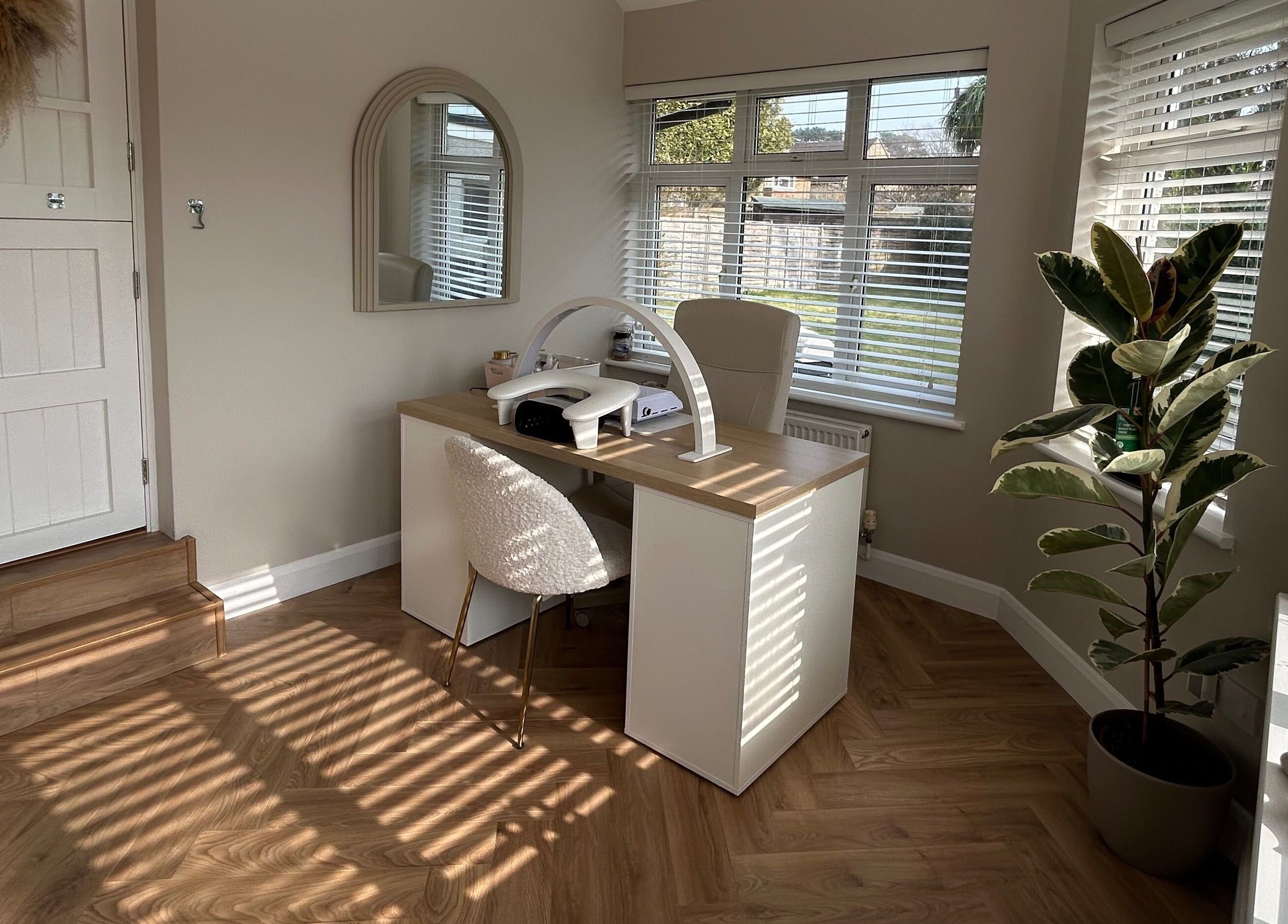 The Nail Room at Epsom Downs in Epsom, England, GB features a chic workspace with modern decor and natural light.