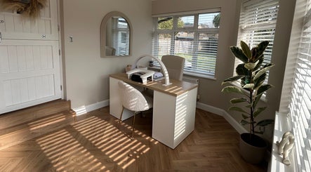 The Nail Room at Epsom Downs in Epsom, England, GB features a chic workspace with modern decor and natural light.