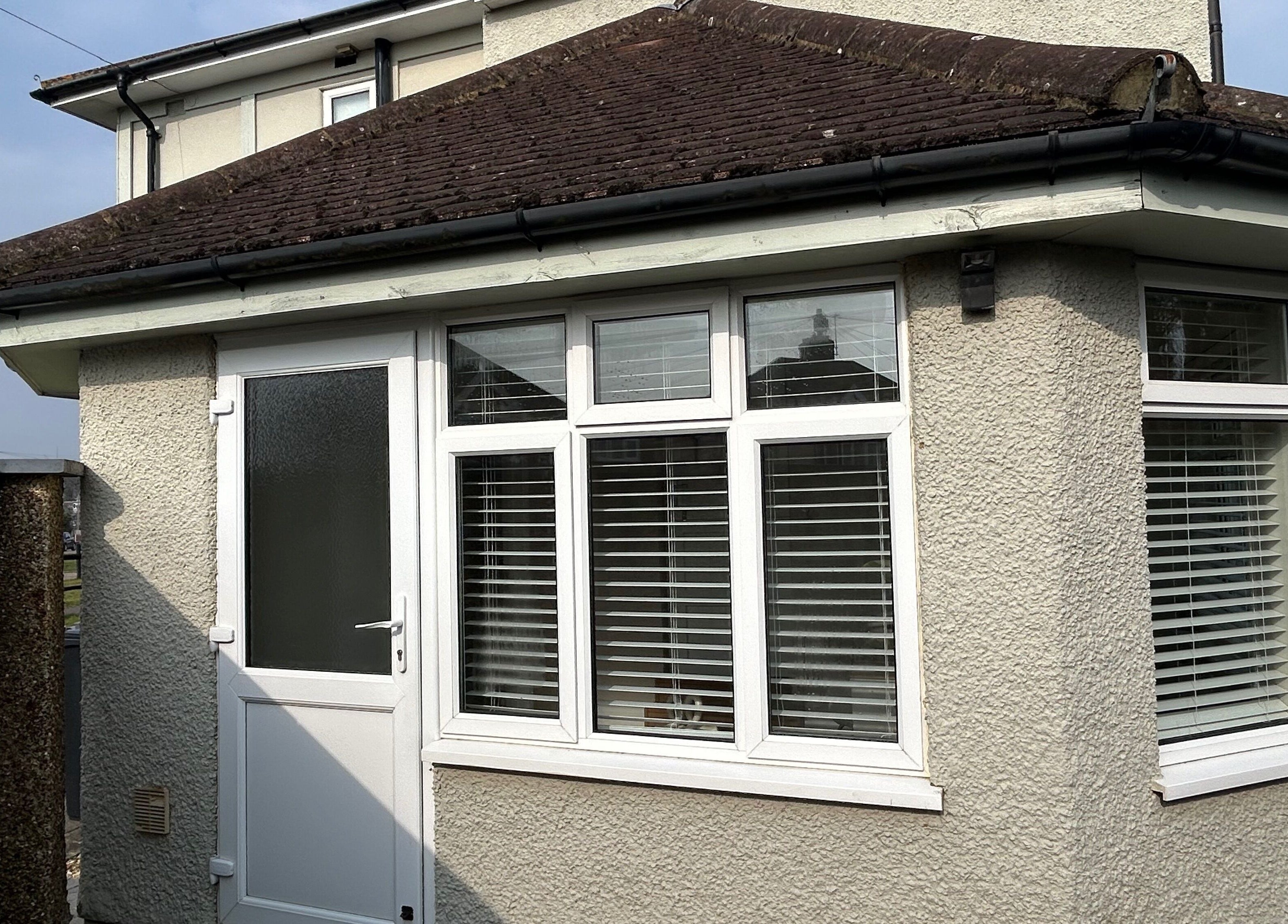 Modern exterior view of The Nail Room at Epsom Downs, highlighting white windows and door, Epsom, England, GB.