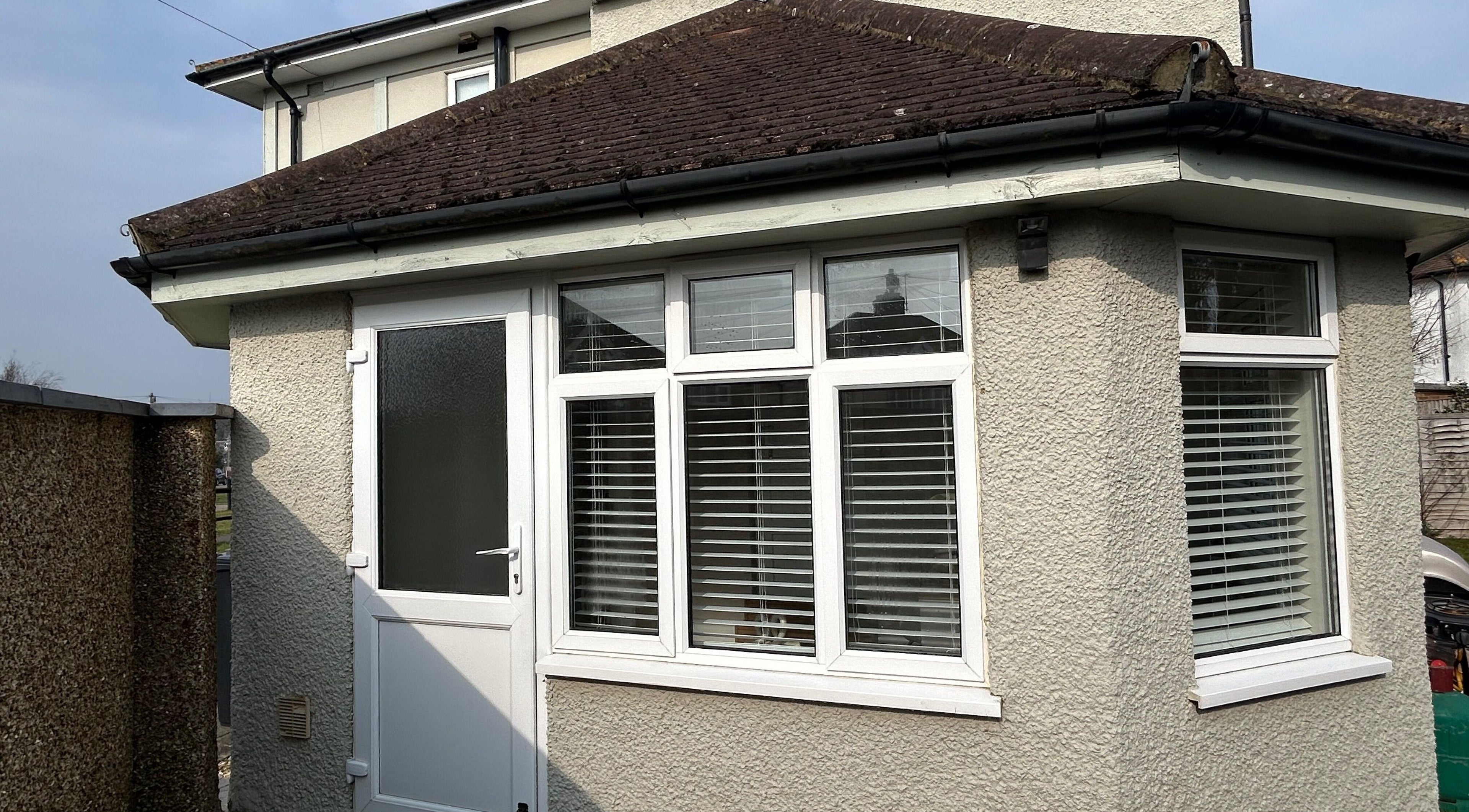 Modern exterior view of The Nail Room at Epsom Downs, highlighting white windows and door, Epsom, England, GB.