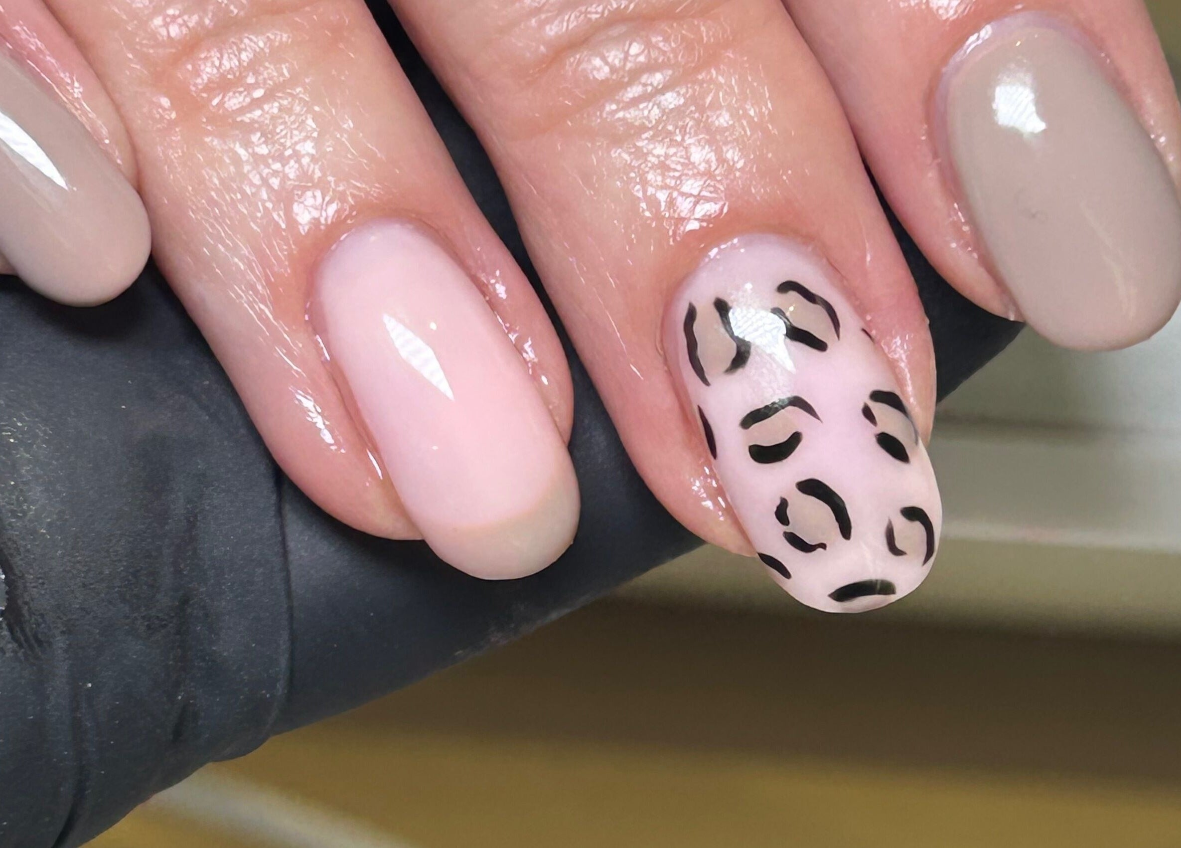 Elegant nail art at The Nail Room at Epsom Downs, Epsom, England, GB, featuring leopard print and soft shades.