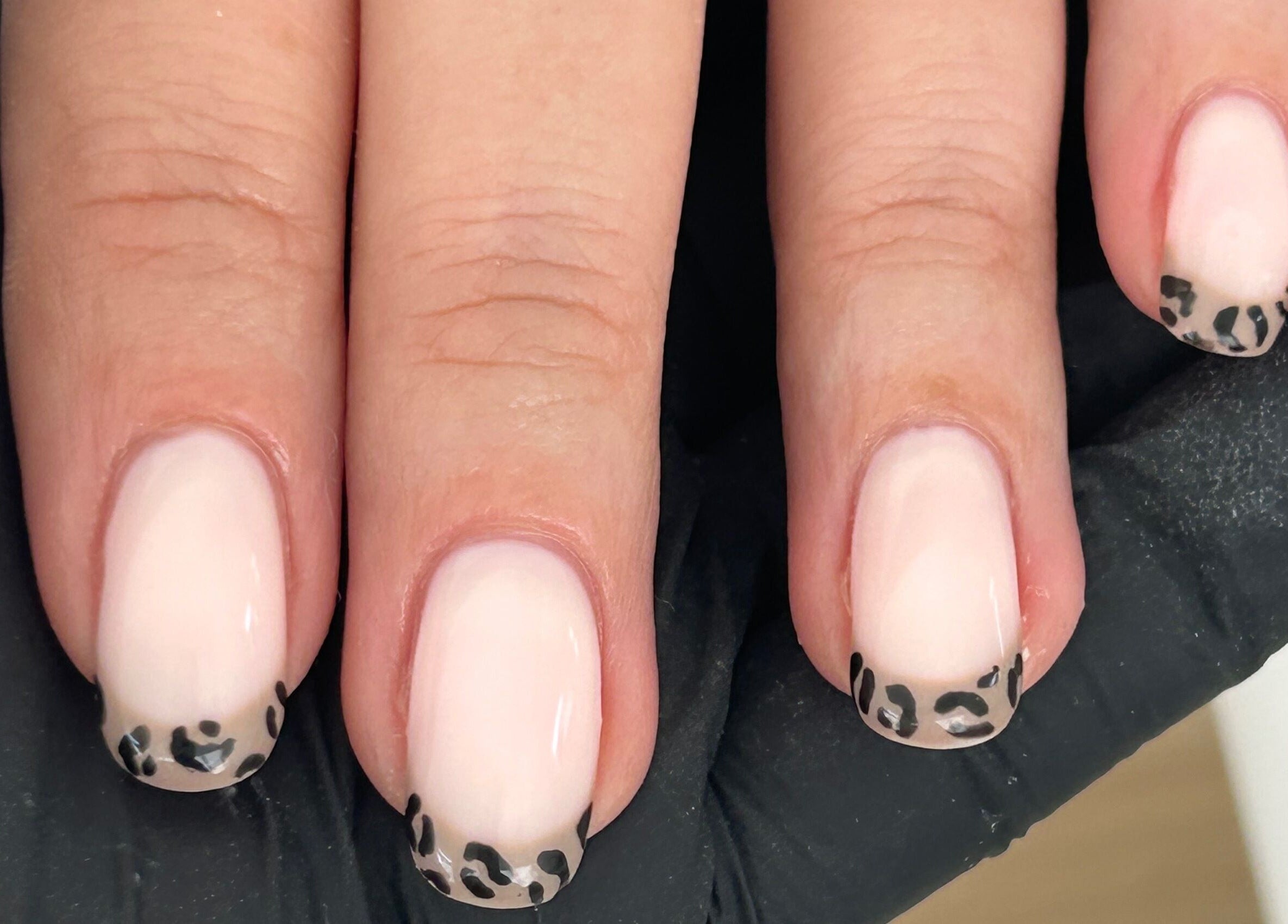Stylish leopard print nail art at The Nail Room at Epsom Downs, Epsom, England, GB.