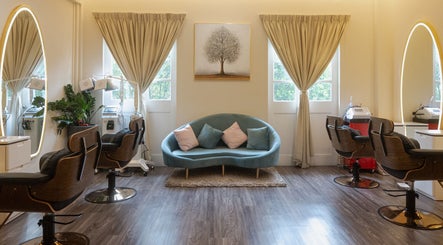 Elegant salon interior at The Hair Lab in Singapore, SG, featuring stylish chairs and a cozy sofa.