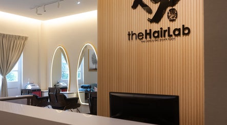 Sleek interior at The Hair Lab, Singapore, SG showcasing stylish, modern decor with illuminated mirrors.