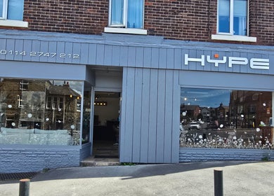 Exterior view of Hype beauty salon in Sheffield, England, GB with elegant signage and large glass windows.