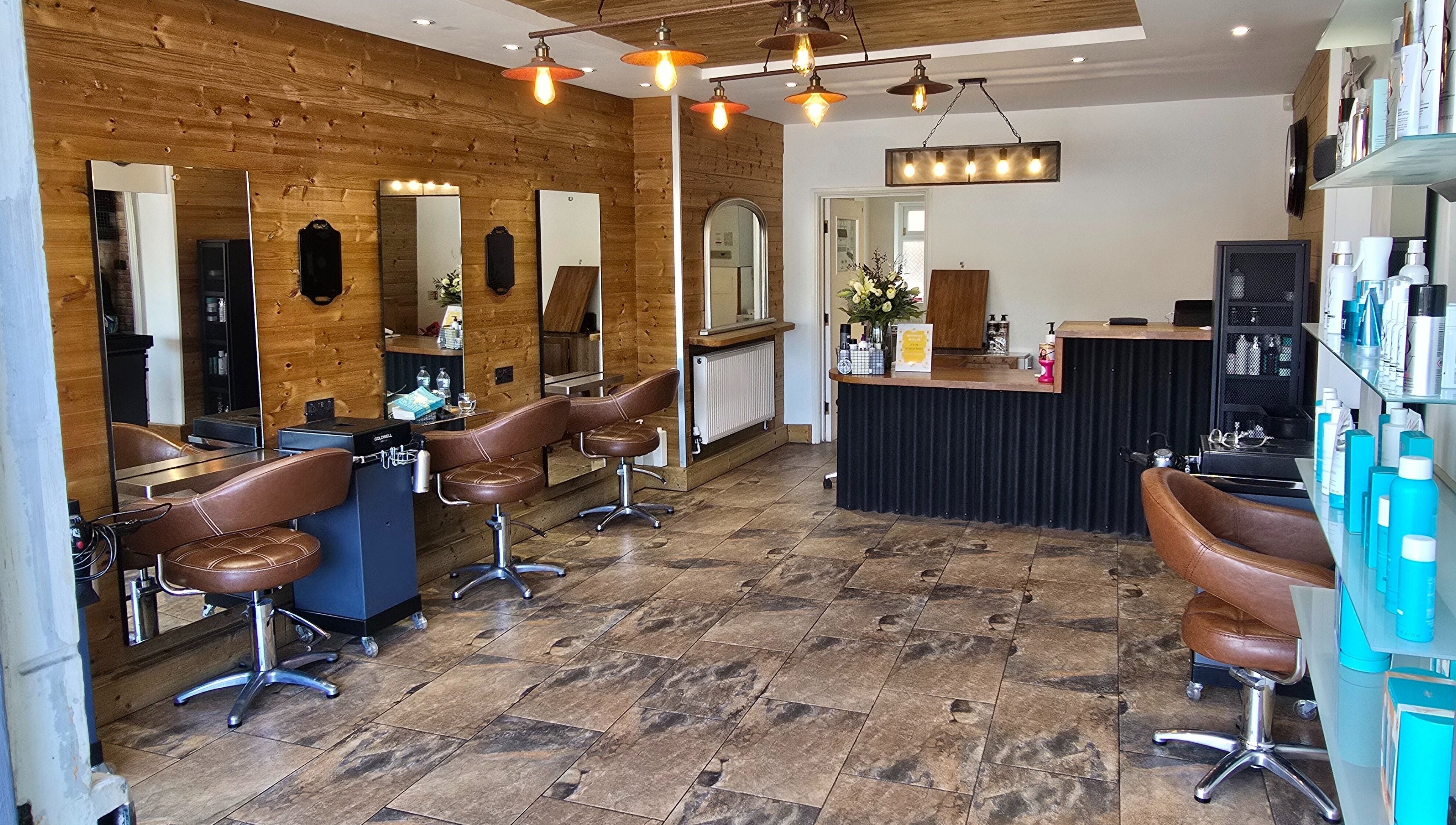 Modern salon interior at Hype Woodseats in Sheffield, England, GB featuring stylish chairs and mirrors.