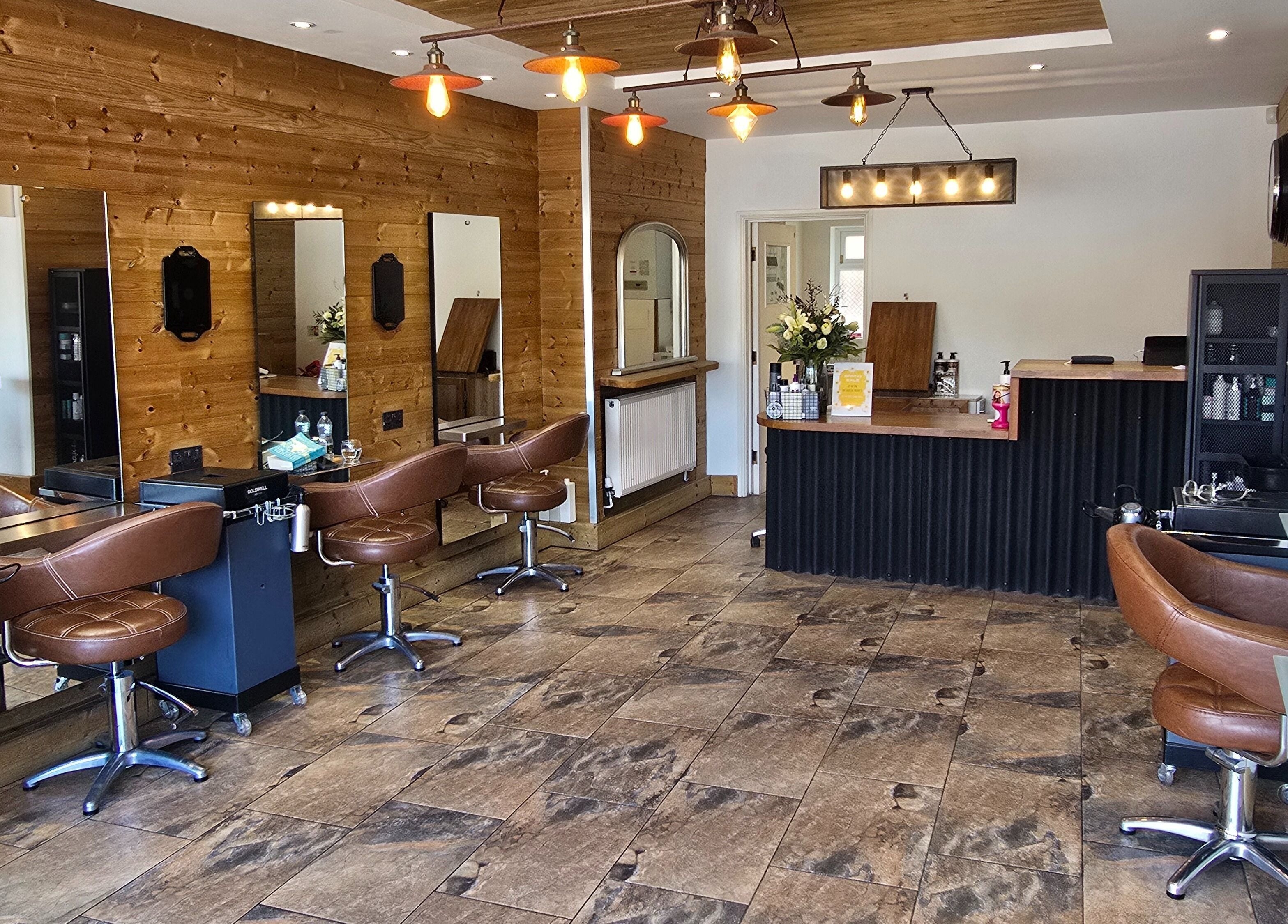 Modern salon interior at Hype Woodseats in Sheffield, England, GB featuring stylish chairs and mirrors.