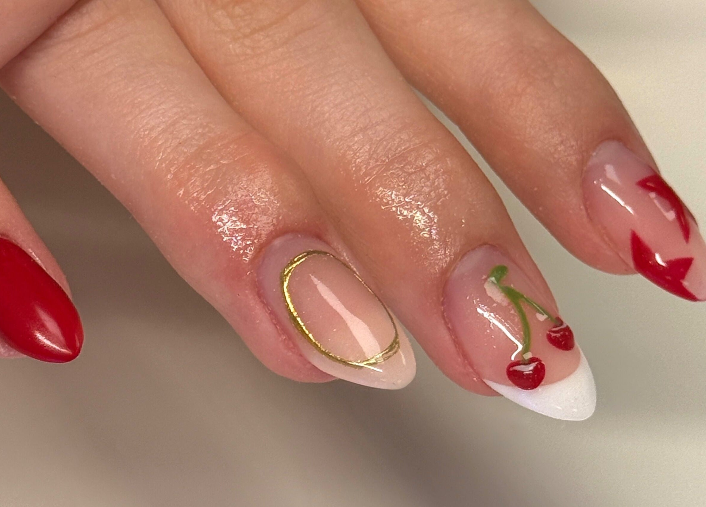 Elegant cherry nail art by Nailsby Georgia, Saint Helens, England, GB showcasing vibrant red designs.