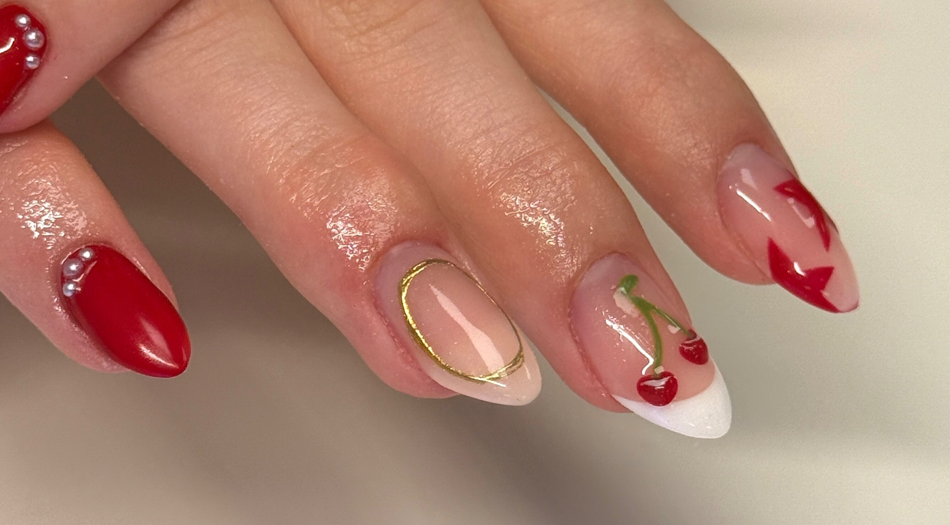 Elegant cherry nail art by Nailsby Georgia, Saint Helens, England, GB showcasing vibrant red designs.