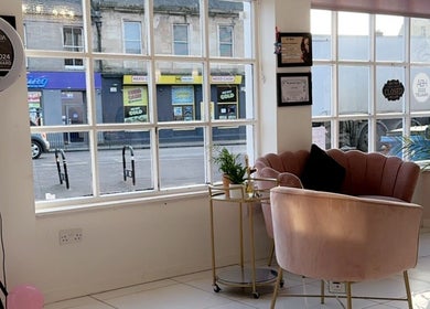 Cozy seating area at The Extension Collective By Amy Louise, Musselburgh, Scotland, GB with pink chairs and large windows.