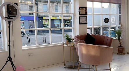 Cozy seating area at The Extension Collective By Amy Louise, Musselburgh, Scotland, GB with pink chairs and large windows.