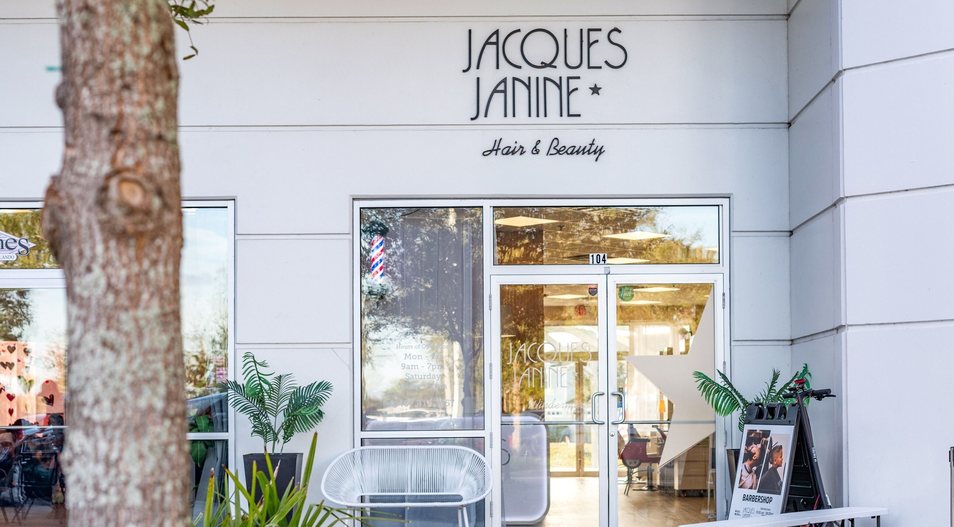 Entrance of Jacques Janine beauty salon in Orlando, Florida, US with plants and a welcoming facade.