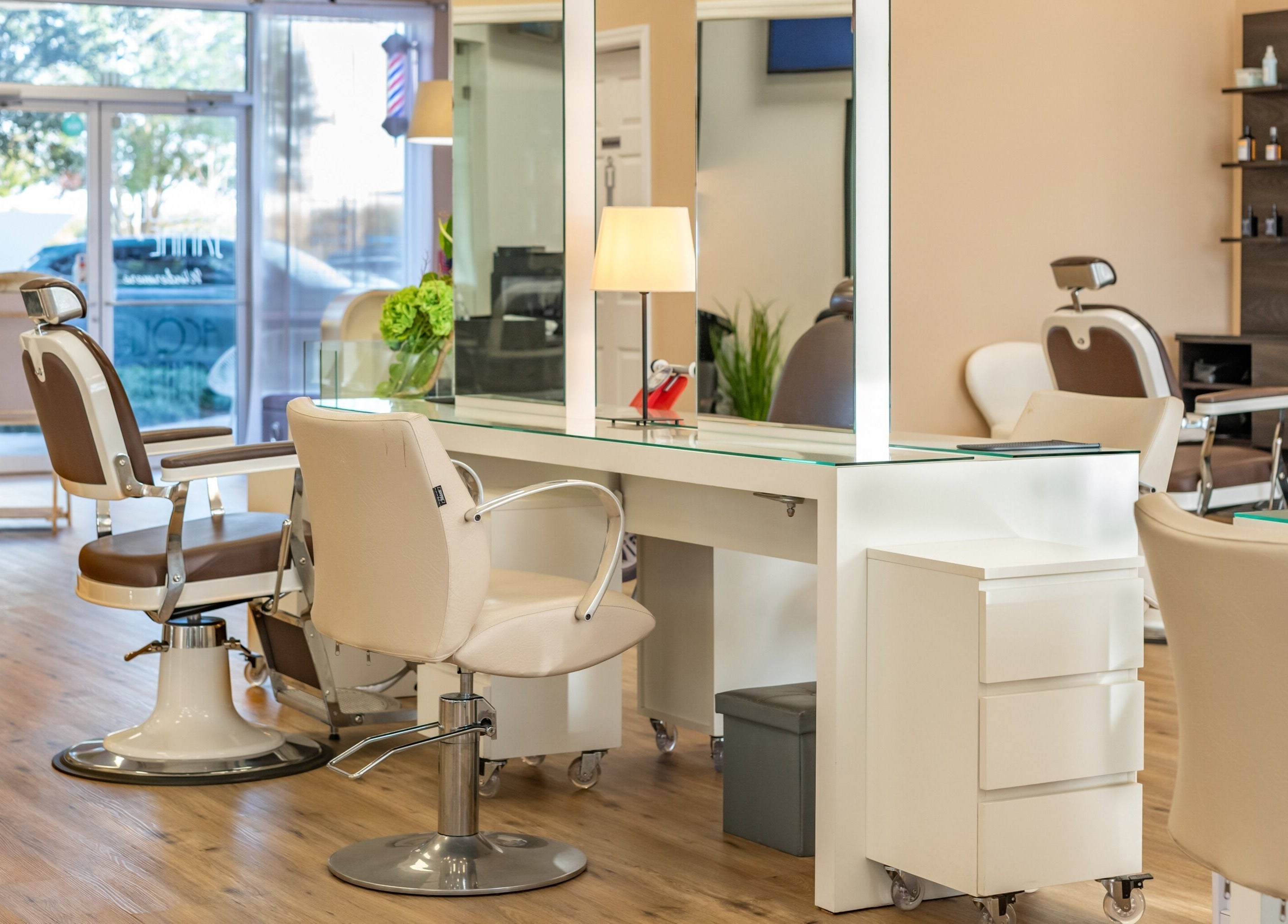 Stylish salon setup at Jacques Janine, Orlando, Florida, US, featuring elegant chairs and mirrors.