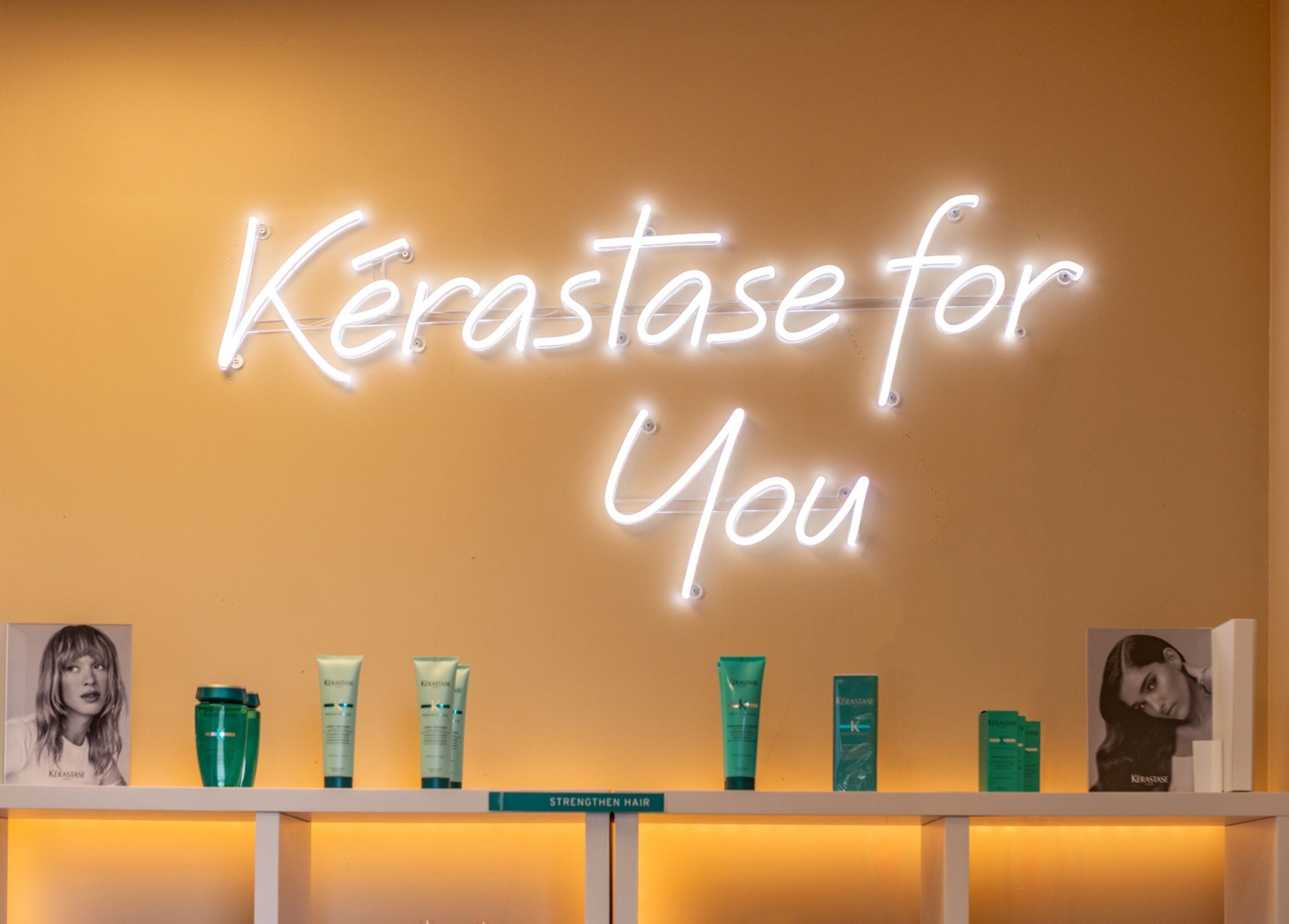 Kerastase product display at Jacques Janine, Orlando, Florida, US with glowing sign and beauty products.