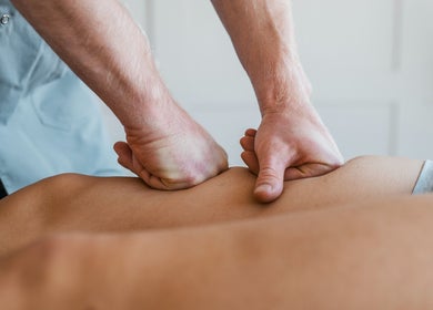 Massage therapy at Jon Foxall Sports Massage, Loughborough, GB shows hands applying pressure on a back.