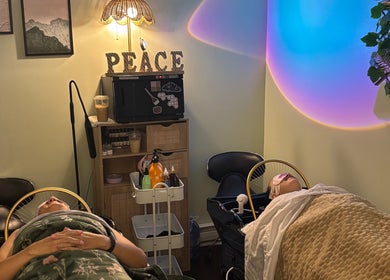 Tranquil spa setup at Lash + Headspa Suite, Fort Erie, Ontario, CA, featuring cozy beds and calming decor.