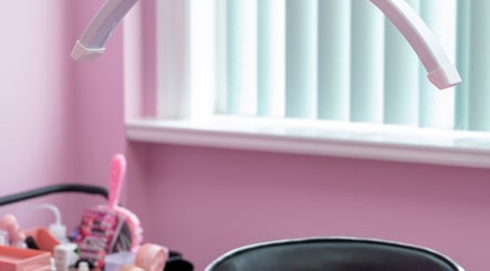 Pink-themed beauty station at Lash + Headspa Suite, Fort Erie, Ontario, CA, showcasing tools and decor.