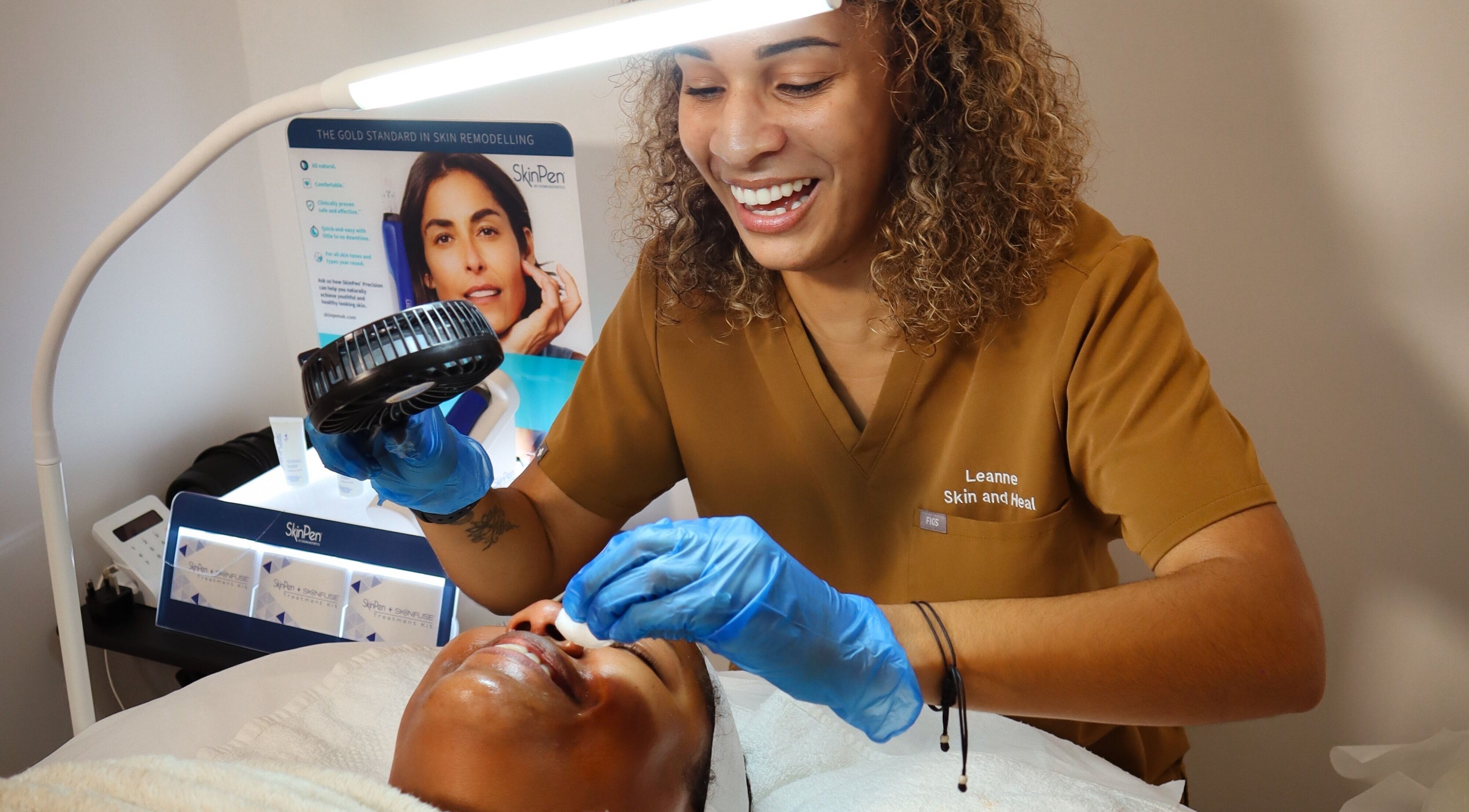 Aesthetician at Skin & Heal in Essex, England, GB performing facial treatment on a client.