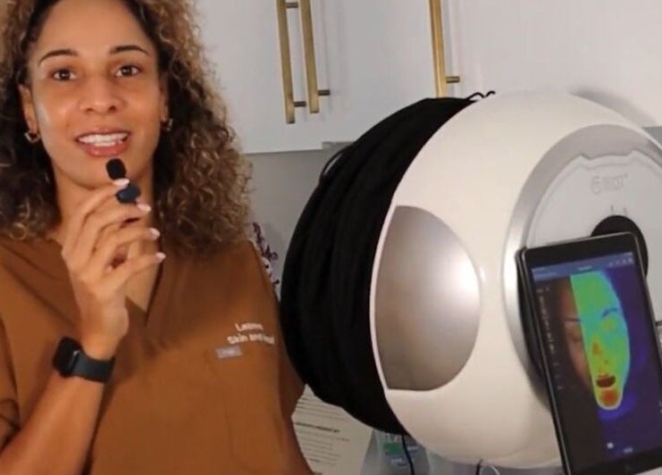 Professional at Skin & Heal in Essex, England using advanced facial scanning technology.