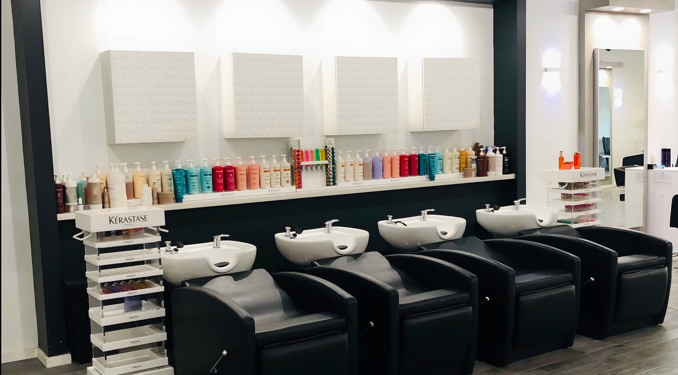 Sleek wash stations at Miva Salon - B Street, Hayward, California, US, showcasing luxury haircare products.