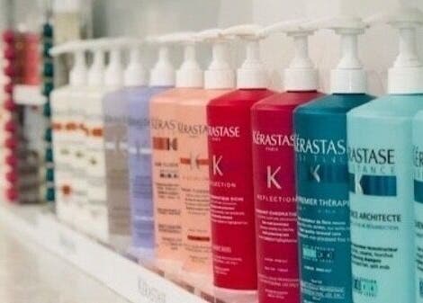 Shelf of colorful haircare bottles at Miva Salon - B Street, Hayward, California, US.