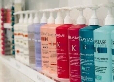 Shelf of colorful haircare bottles at Miva Salon - B Street, Hayward, California, US.