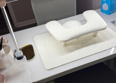 Modern nail station at Nails By Emm, Duncan, South Carolina, US, showcasing sleek white desk and manicure tools.