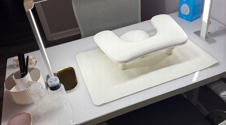 Modern nail station at Nails By Emm, Duncan, South Carolina, US, showcasing sleek white desk and manicure tools.