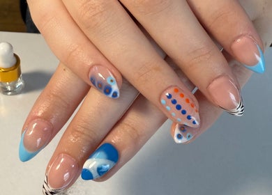 Artistic blue and orange dotted nails at Nails By Emm, Duncan, South Carolina, US.