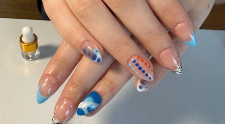 Artistic blue and orange dotted nails at Nails By Emm, Duncan, South Carolina, US.